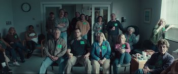 Movie still from “Stronger” (2017), directed by David Gordon Green – A group of people sitting in front of a window; Wide shot, High angle