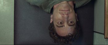 Movie still from “Stronger” (2017), directed by David Gordon Green – A person upside down on the ground; Close Up shot, Overhead angle