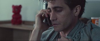 Movie still from “Stronger” (2017), directed by David Gordon Green – A man is talking on a cell phone; Close Up shot, Over the shoulder angle
