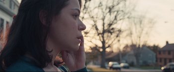 Movie still from “Stronger” (2017), directed by David Gordon Green – A woman with a tattoo on her face looks to the side; Close Up shot, Over the shoulder angle