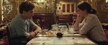 Movie still from “Stronger” (2017), directed by David Gordon Green – A man and woman sitting at a table in a restaurant; Medium shot, Over the shoulder angle