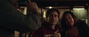 Movie still from “Stronger” (2017), directed by David Gordon Green – A man giving a thumbs - up sign in front of a crowd; Close Up shot, Over the shoulder angle