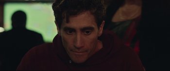 Movie still from “Stronger” (2017), directed by David Gordon Green – A person wearing a hooded sweatshirt; Close Up shot, Over the shoulder angle