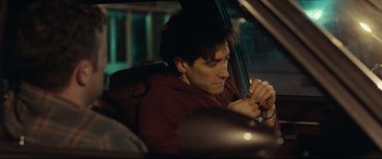 Movie still from “Stronger” (2017), directed by David Gordon Green – A man sitting in the driver's seat of a car at night; Close Up shot, Over the shoulder angle
