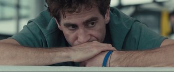 Movie still from “Stronger” (2017), directed by David Gordon Green – A person with his hand on his chin; Close Up shot, Low angle
