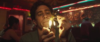 Movie still from “Stronger” (2017), directed by David Gordon Green – A man holding a sparkler in his hands; Close Up shot, Low angle