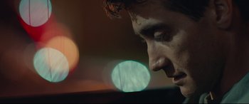 Movie still from “Stronger” (2017), directed by David Gordon Green – A man's face with a blurry background; Extreme Close Up shot, Low angle