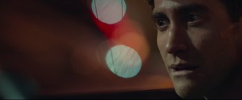 Movie still from “Stronger” (2017), directed by David Gordon Green – A man's face in front of a red and white light; Extreme Close Up shot, Over the shoulder angle