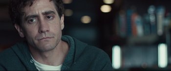 Movie still from “Stronger” (2017), directed by David Gordon Green – A person wearing a hoodie; Close Up shot, Over the shoulder angle