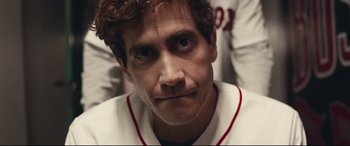 Movie still from “Stronger” (2017), directed by David Gordon Green – A baseball player in a white uniform; Close Up shot, Over the shoulder angle