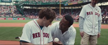 Movie still from “Stronger” (2017), directed by David Gordon Green – Two baseball players talking to each other on a field; Medium shot, Over the shoulder angle