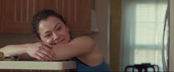 Movie still from “Stronger” (2017), directed by David Gordon Green – A woman leaning on a chair in a kitchen; Close Up shot, Over the shoulder angle
