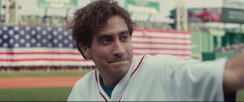 Movie still from “Stronger” (2017), directed by David Gordon Green – A baseball player smiling for the camera; Close Up shot, Over the shoulder angle