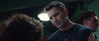 Movie still from “Stronger” (2017), directed by David Gordon Green – A person with a light in the background; Close Up shot, Over the shoulder angle