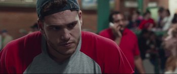 Movie still from “Stronger” (2017), directed by David Gordon Green – A man in a gray shirt and a red shirt talking on a phone; Close Up shot, Low angle