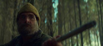 Movie still from “Sweet Tooth” (2021), created by Jim Mickle – A person holding a stick in a forest; Close Up shot, Low angle