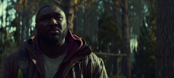 Movie still from “Sweet Tooth” (2021), created by Jim Mickle – A person wearing a jacket near a forest; Close Up shot, Low angle