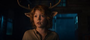Movie still from “Sweet Tooth” (2021), created by Jim Mickle – A young boy with horns on his head; Close Up shot, Over the shoulder angle