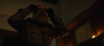 Movie still from “Sweet Tooth” (2021), created by Jim Mickle – A man with a goatee and a beard wearing sunglasses; Close Up shot, Low angle