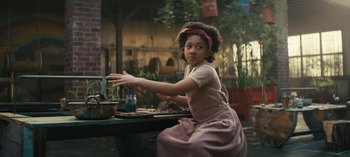 Movie still from “Sweet Tooth” (2021), created by Jim Mickle – A young girl sitting at a table with a plate of food in front of her; Medium shot, High angle