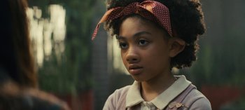 Movie still from “Sweet Tooth” (2021), created by Jim Mickle – A young girl wearing a red and white polka dot headband; Close Up shot, Over the shoulder angle