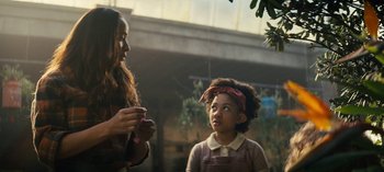 Movie still from “Sweet Tooth” (2021), created by Jim Mickle – A woman and a girl are standing next to each other; Medium shot, Over the shoulder angle