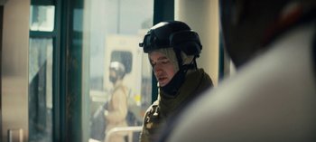 Movie still from “Sweet Tooth” (2021), created by Jim Mickle – A man wearing a helmet is sitting in a room; Close Up shot, Over the shoulder angle