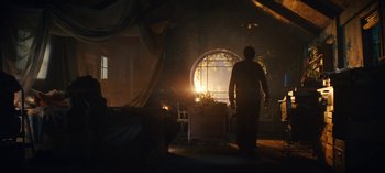 Movie still from “Sweet Tooth” (2021), created by Jim Mickle – A man standing in front of an open fire place; Wide shot, Low angle