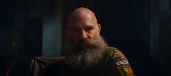 Movie still from “Sweet Tooth” (2021), created by Jim Mickle – A bald man with a long beard is looking straight ahead; Close Up shot, Low angle