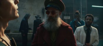Movie still from “Sweet Tooth” (2021), created by Jim Mickle – A man with a beard wearing a red coat and a hat; Medium shot, Low angle