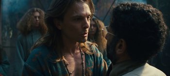 Movie still from “Sweet Tooth” (2021), created by Jim Mickle – A man smoking a cigarette while standing next to another man; Close Up shot, Over the shoulder angle
