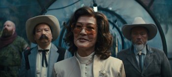 Movie still from “Sweet Tooth” (2021), created by Jim Mickle – A woman in a white jacket and a pair of sunglasses; Medium shot, Low angle