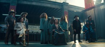 Movie still from “Sweet Tooth” (2021), created by Jim Mickle – A group of people dressed in robes standing in a street; Wide shot, Low angle