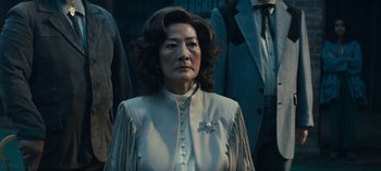 Movie still from “Sweet Tooth” (2021), created by Jim Mickle – An older woman wearing a white dress with a star on her chest; Close Up shot, Over the shoulder angle