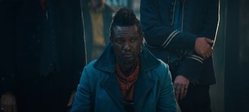 Movie still from “Sweet Tooth” (2021), created by Jim Mickle – A man in a blue coat is looking at the camera; Close Up shot, Over the shoulder angle