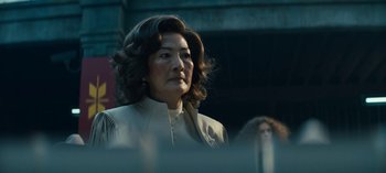 Movie still from “Sweet Tooth” (2021), created by Jim Mickle – An older woman in a white jacket looking off into the distance; Medium shot, Low angle