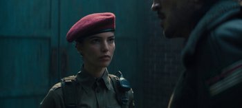 Movie still from “Sweet Tooth” (2021), created by Jim Mickle – A woman in a military uniform is talking to a man in a red hat; Close Up shot, Over the shoulder angle