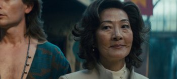 Movie still from “Sweet Tooth” (2021), created by Jim Mickle – An older asian woman looking up into the sky; Close Up shot, Over the shoulder angle