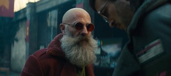 Movie still from “Sweet Tooth” (2021), created by Jim Mickle – An old man with a long beard wearing sunglasses; Close Up shot, Low angle