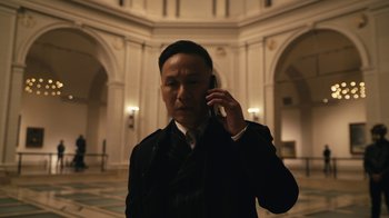Movie still from “Mr. Robot” (2015), created by Sam Esmail – A man talking on a cell phone while wearing a suit and tie; Close Up shot, Low angle