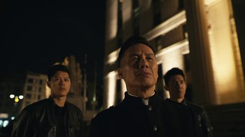 Movie still from “Mr. Robot” (2015), created by Sam Esmail – A group of men standing next to each other in front of a building at night; Medium shot, Low angle