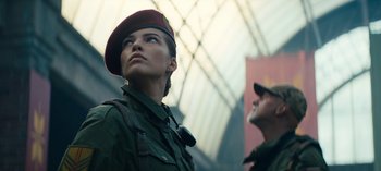 Movie still from “Sweet Tooth” (2021), created by Jim Mickle – A woman in a military uniform and a man in a hat; Close Up shot, Low angle