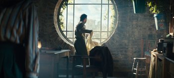 Movie still from “Sweet Tooth” (2021), created by Jim Mickle – A person standing in front of a large round window; Wide shot, Low angle