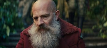 Movie still from “Sweet Tooth” (2021), created by Jim Mickle – A bald man with a long beard wearing a red jacket; Close Up shot, Over the shoulder angle