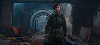 Movie still from “Sweet Tooth” (2021), created by Jim Mickle – A woman in a military uniform holding a gun; Medium shot, Low angle