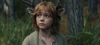 Movie still from “Sweet Tooth” (2021), created by Jim Mickle – A young boy with horns on his head; Close Up shot, Over the shoulder angle