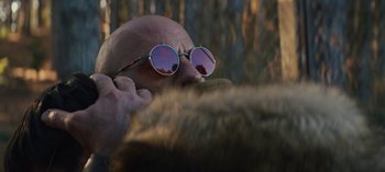 Movie still from “Sweet Tooth” (2021), created by Jim Mickle – A bald man with sunglasses on his head; Close Up shot, Low angle