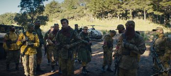 Movie still from “Sweet Tooth” (2021), created by Jim Mickle – A group of men standing next to each other; Wide shot, Over the shoulder angle