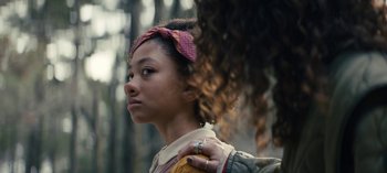 Movie still from “Sweet Tooth” (2021), created by Jim Mickle – A young girl is holding her hand on the shoulder of another young girl; Close Up shot, Over the shoulder angle