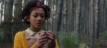 Movie still from “Sweet Tooth” (2021), created by Jim Mickle – A young girl holding a camera in a wooded area; Close Up shot, High angle